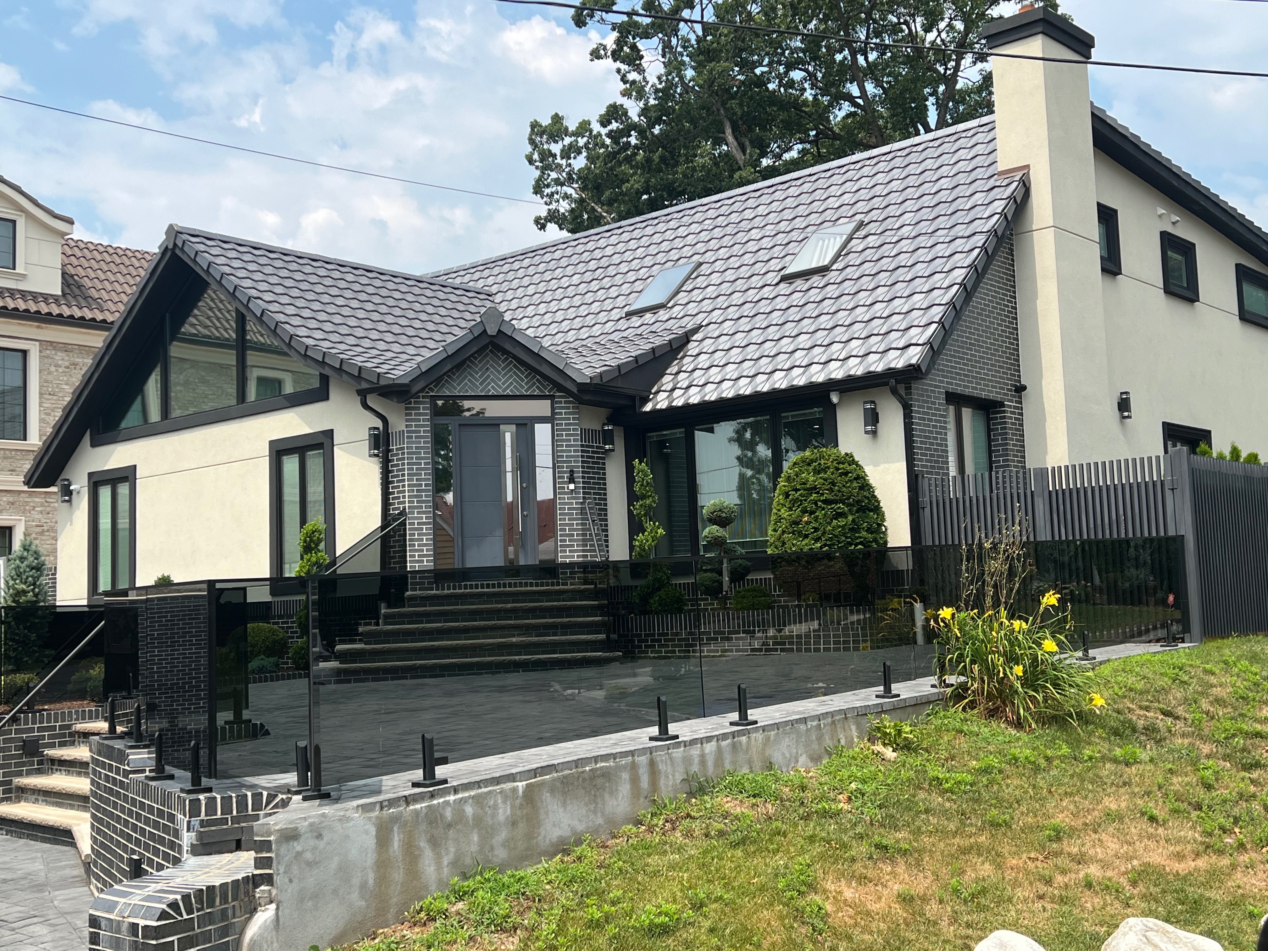 Contemporary home with sophisticated gray slate clay tile roofing and modern architecture